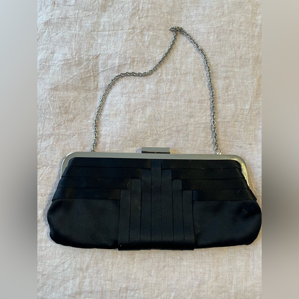 BCBG Max Azria Black satin purse with silver chain.